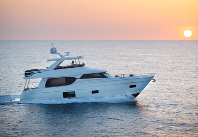 beautiful sunset illuminates yacht making its way across horizon