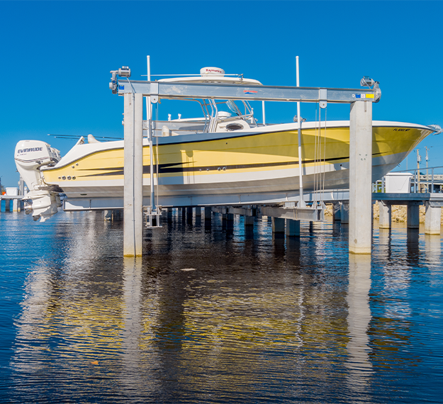 yellow and white boat in boat lift storage