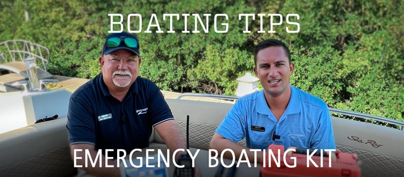 Captains Keith and Nick sit on the back of a Sea Ray boat with emergency boating kit supplies in front of them.