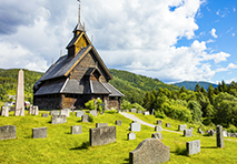 church and cemetery on green hills in norway