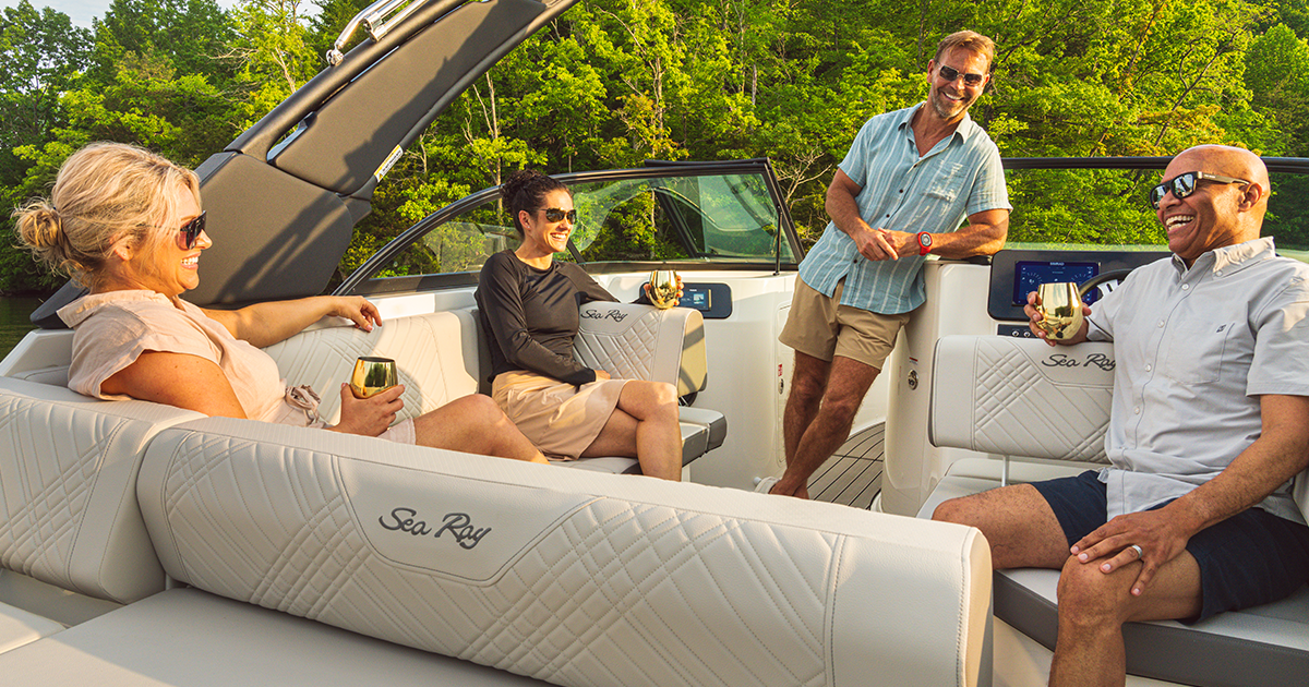 Four people relax and enjoy drinks on a luxury boat
