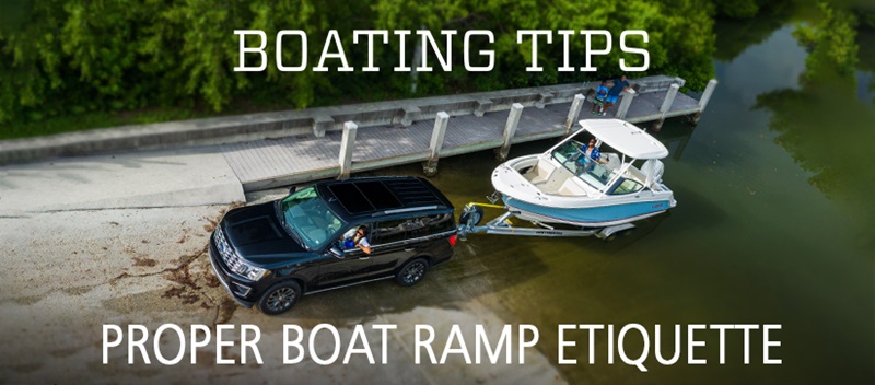 Truck pulling a boat trailer out of the water