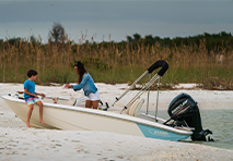 boston whaler pulling up on the shore