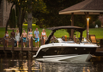 people standing on dock admiring boat