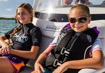 two girls on bow cushion of boston whaler