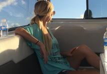 woman siting on a yacht and looking out to the water