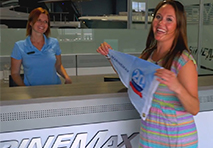 two women standing holding a burgee