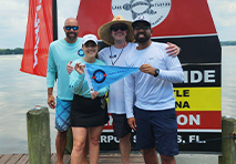 marinemax burgee being held by group of people