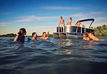 people swimming close to a boat