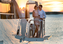 couple on yacht enjoying romantic sunset