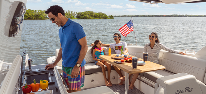 Family grilling on a boat