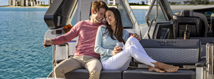 Two people smiling and sitting on Galeon Yacht