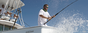 man fishing off a boat