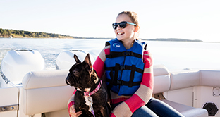 girl on a boat with a puppy