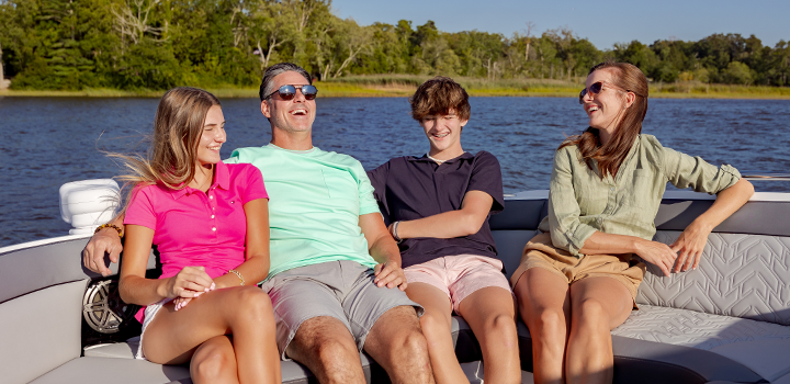 family sitting on a boat