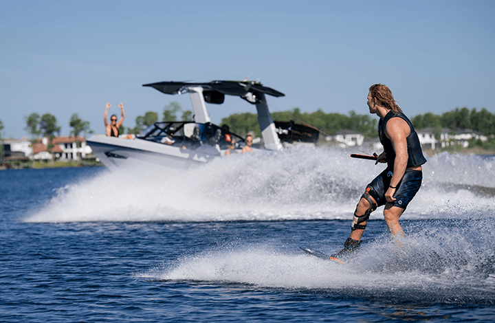 person wake surfing behind a boat