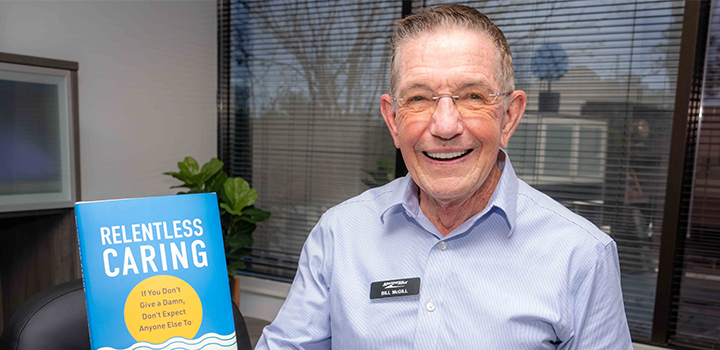bill mcgill holding his book