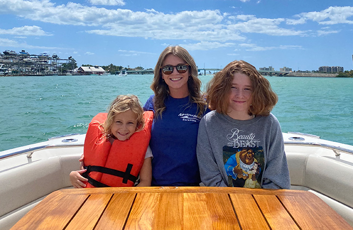 heather mess on a boat with two young girls