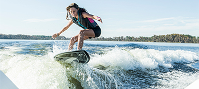 Girl surfing behind a boat