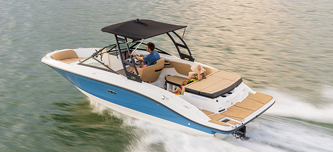 A blue and white Sea Ray Bowrider SPX 210 races across the water