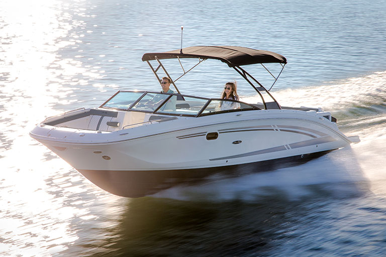 Sea Ray boat cruising with smiling couple onboard