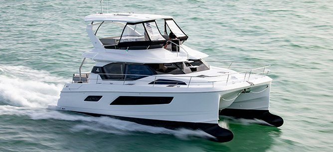 A white and black Aquila Power Catamaran on the water