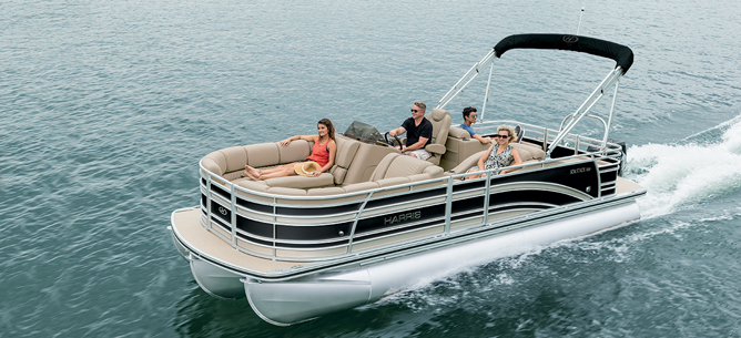 family leisurely traveling across water on pontoon boat