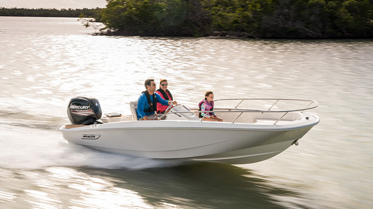 group of three people on white and beige Boston Whaler 160 Super Sport in the water