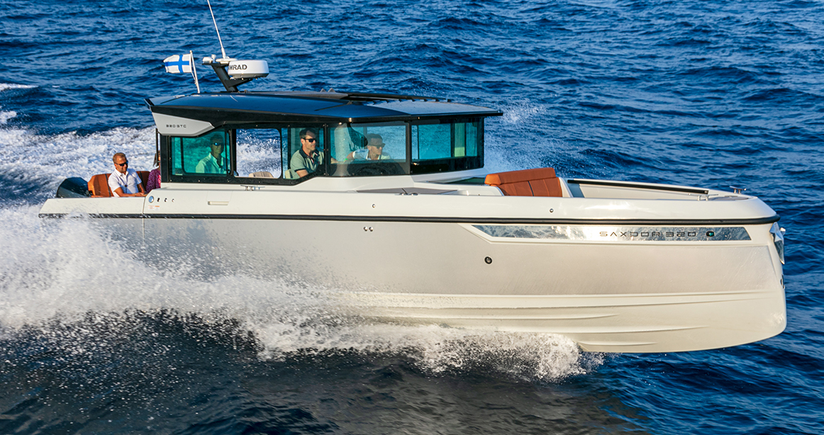 Saxdor boat running in water with people on it 