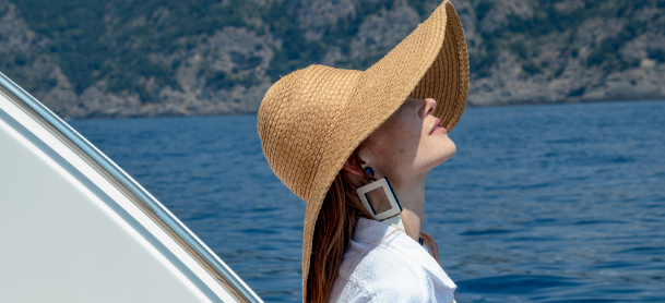 Woman wearing a sun hat on a boat