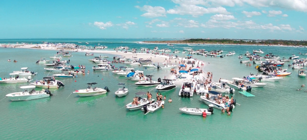 Many boats out on a sand bar