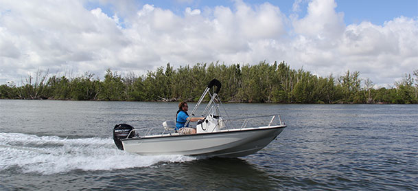 Boston Whaler 150 Montauk in the water with man at the helm