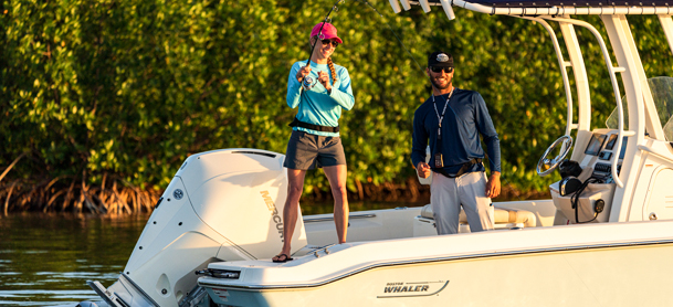 two people fishing off a boat