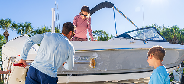 a family cleaning their boat before hitting the water