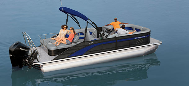 Two men and two woman sitting on black and blue L Series Bennington pontoon