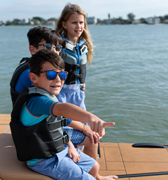 kids pointing at something in the water