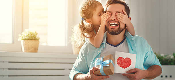 Father and daughter with Father's Day card and gift