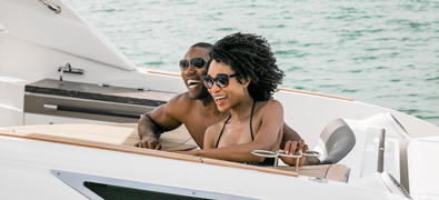 Couple on yacht smiling and laughing