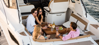 group seated on yacht deck relaxing with some fine wine