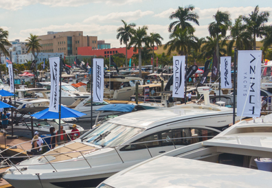 group viewing yachts of various brands like Azimut and Galeon at boat show