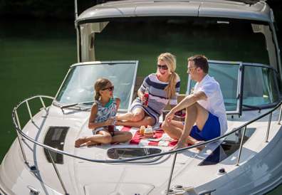 Family enjoys picnic on bow of boat