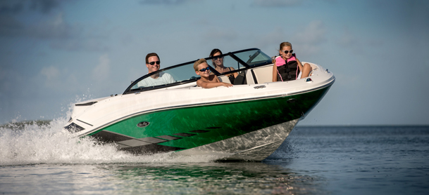 Family on speedboat having exhilerating fun racing across water