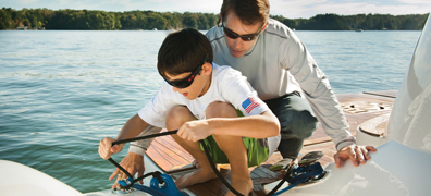 Father teaching son boating knots