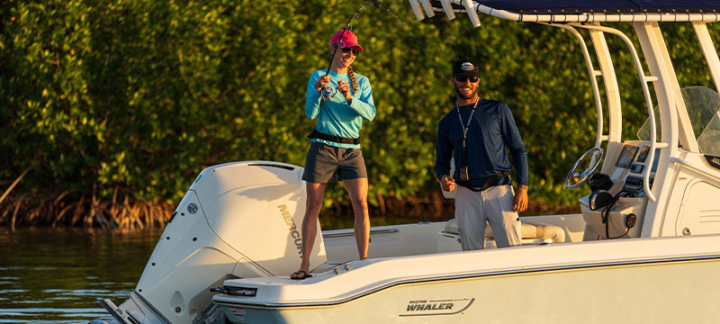 Man and woman fishing on Boston Whaler boat