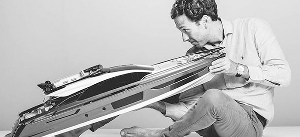man holding and looking at model of the Azimut S10