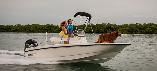 Couple and dog on Boston Whaler 170 Dauntless