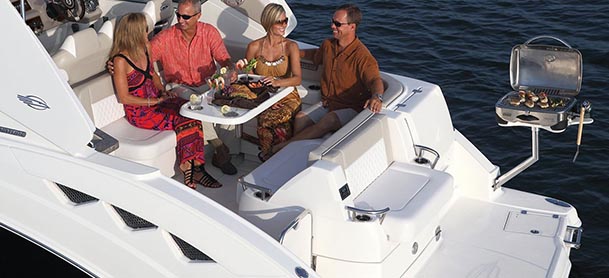 people eating on the aft deck of a boat