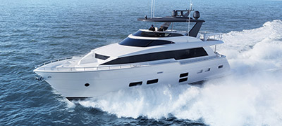 Hatteras 70 Motor Yacht cruising through beautiful blue waters.
