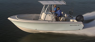 close up of a sailfish boat running over very dark waters and a person at the helm