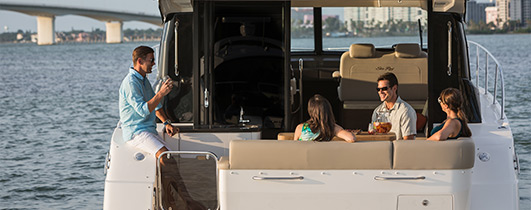 Sea Ray 470 Sundancer with people lounging on aft seating